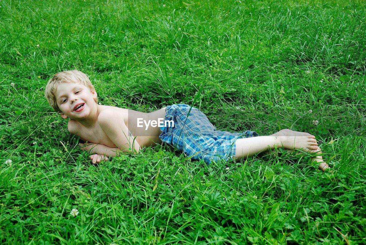 Portrait of smiling boy on grassy field