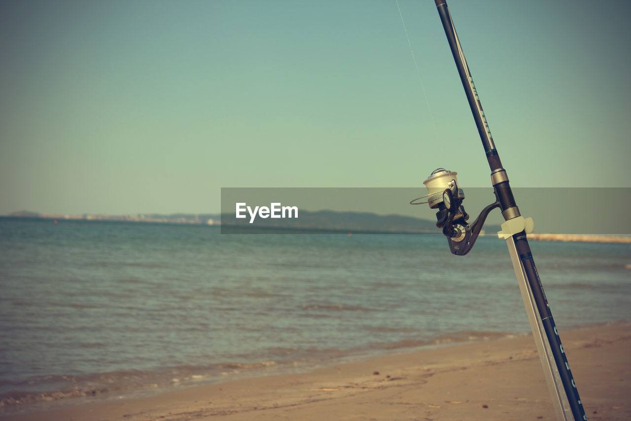 Fishing rod sea in background