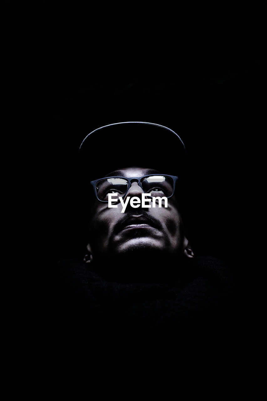 Close-up of illuminated man's face