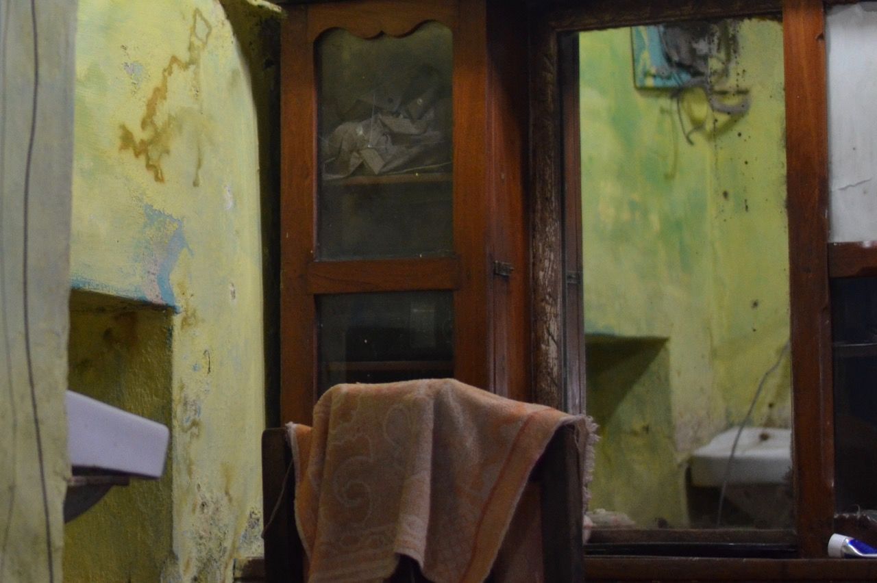 CLOSE-UP OF WINDOW IN ABANDONED ROOM