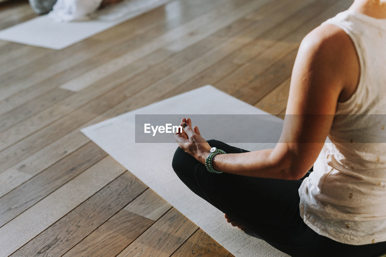 Woman meditating in yoga studio