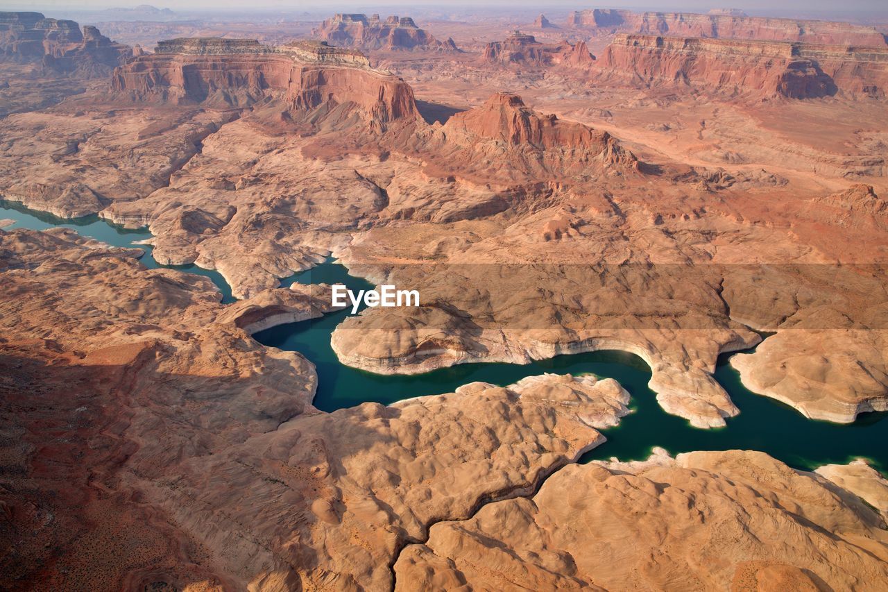 Aerial view of river flowing amidst canyon