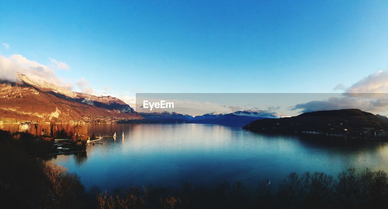 Calm lake with mountains in background