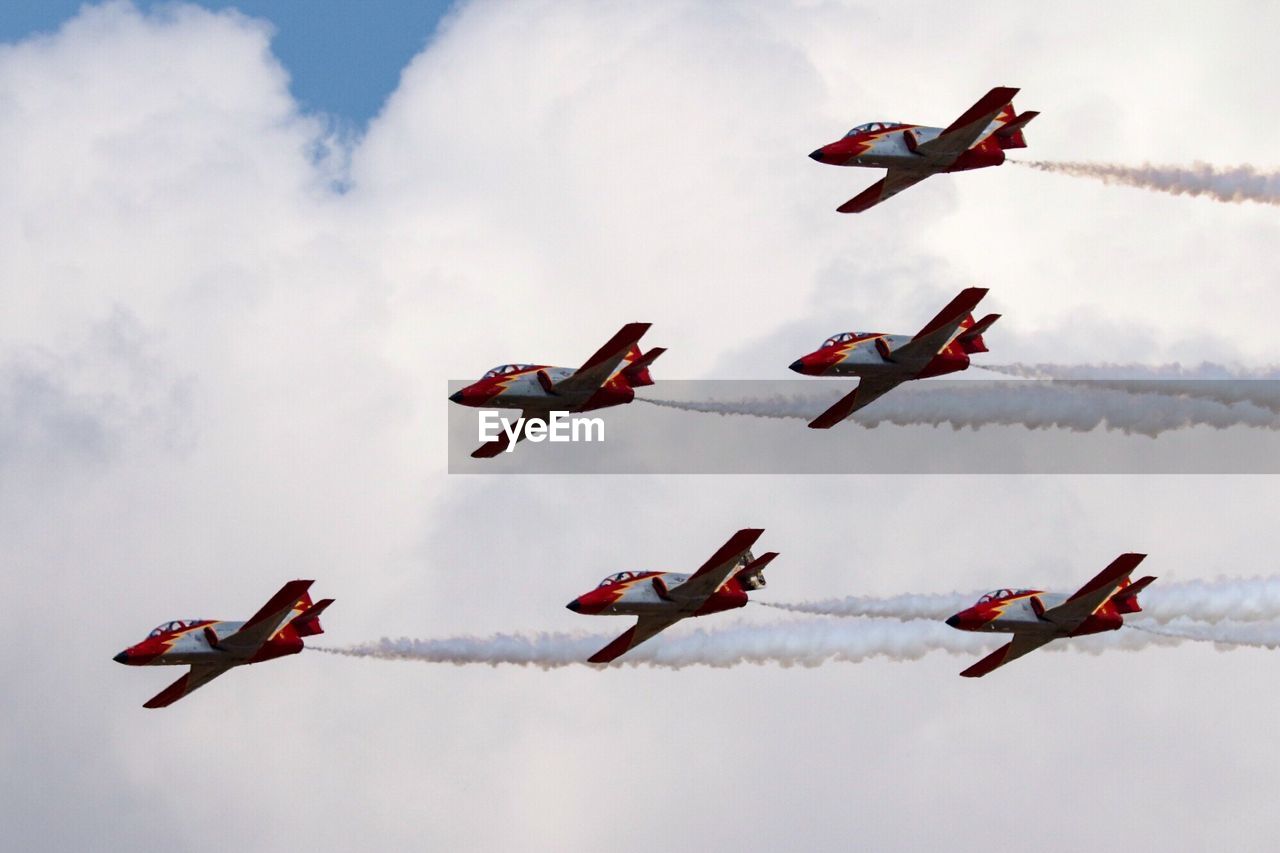 Low angle view of fighter planes flying against sky