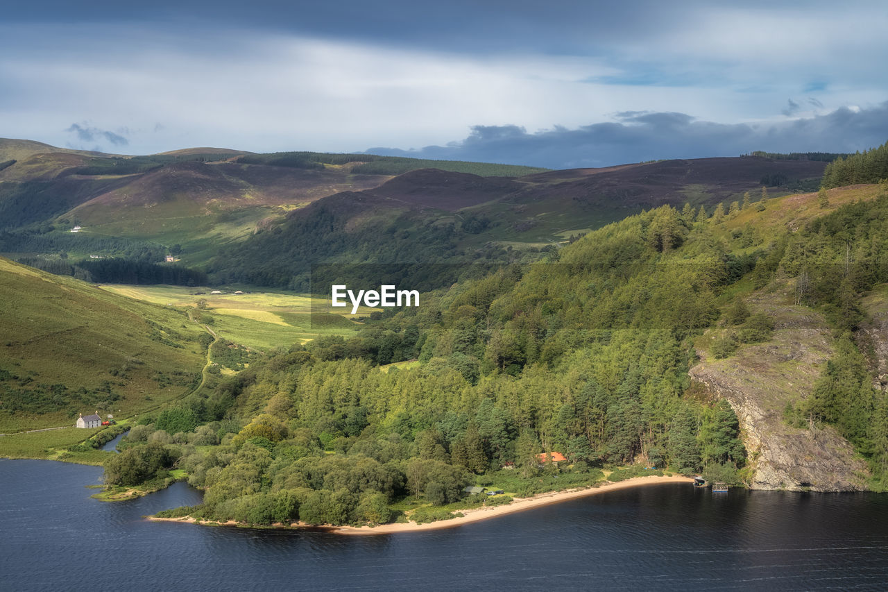 Panorama with houses, lake, beach, forest and mountains. lough dan in wicklow mountains, ireland