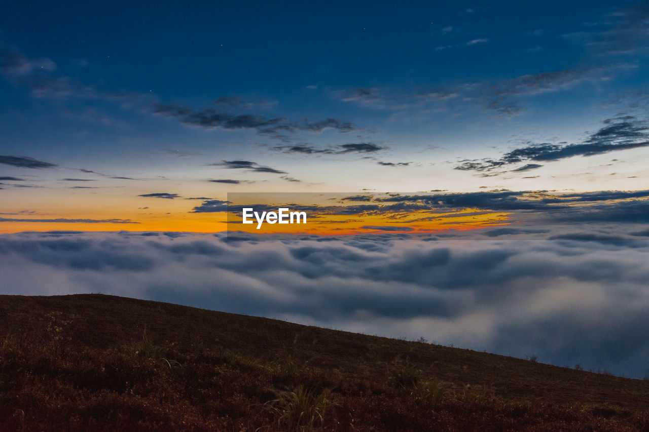 SCENIC VIEW OF LAND AGAINST SKY DURING SUNSET