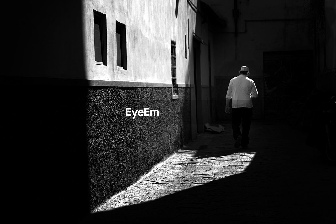 Rear view of man walking on street