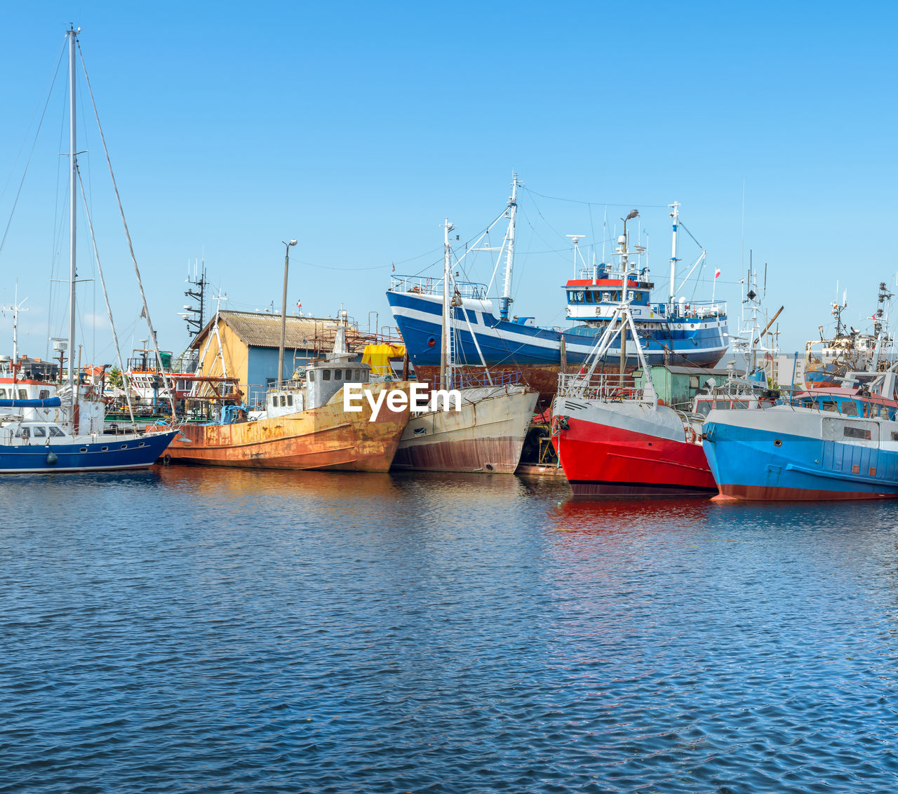 Cutter ships and sailboat standing in the harbour in darlowko, 