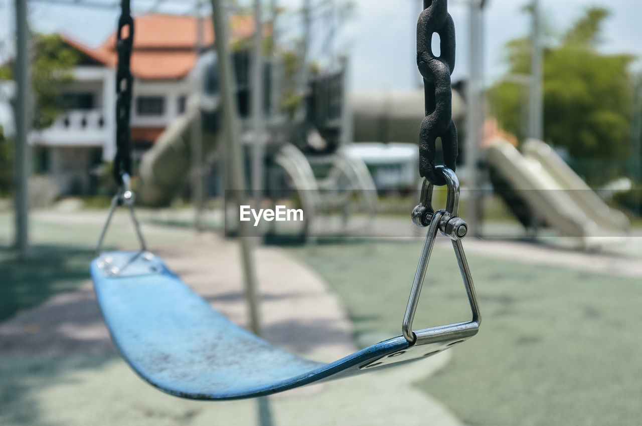 CLOSE-UP OF SWING AT PLAYGROUND