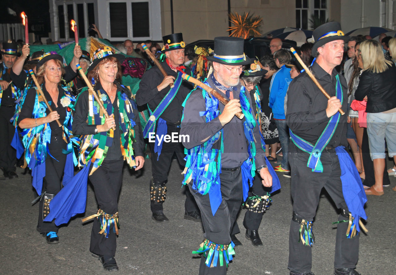 GROUP OF PEOPLE DANCING IN TRADITIONAL CLOTHING