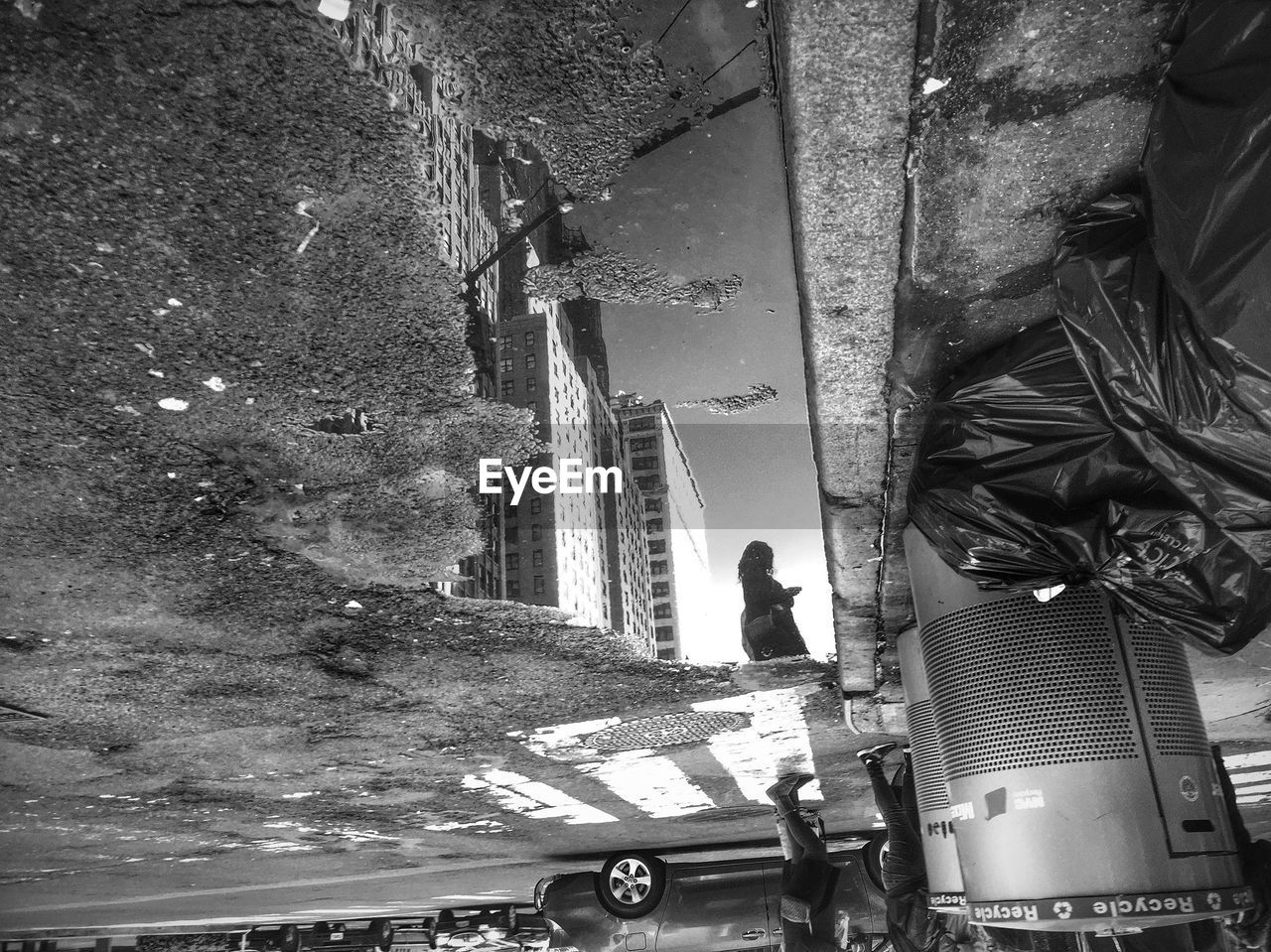 Woman reflected in puddle