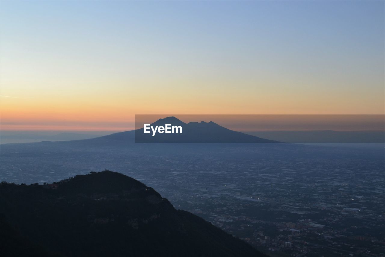 Scenic view of silhouette mountains against sky during sunset