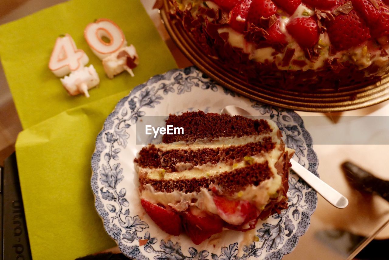 High angle view of birthday cake with candles on table