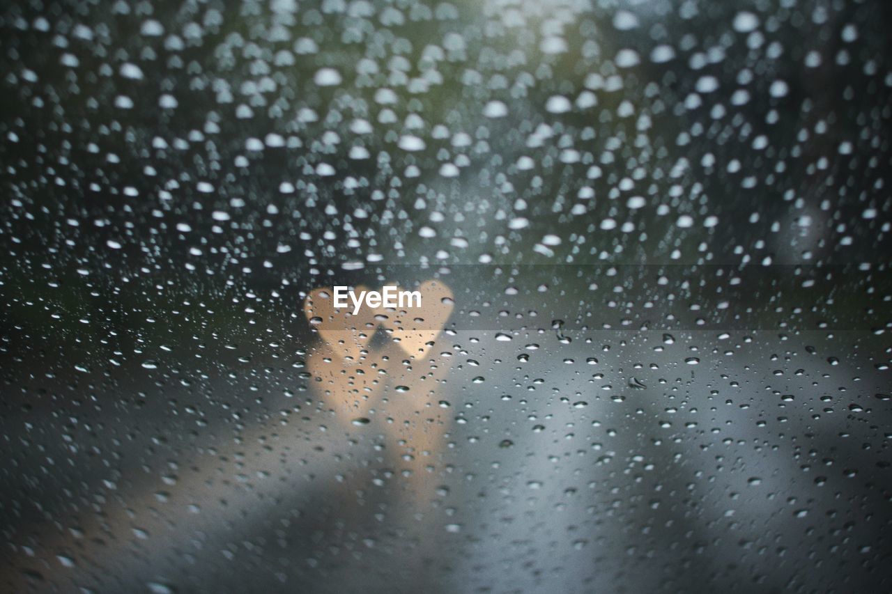 CLOSE-UP OF WET WINDOW IN RAIN