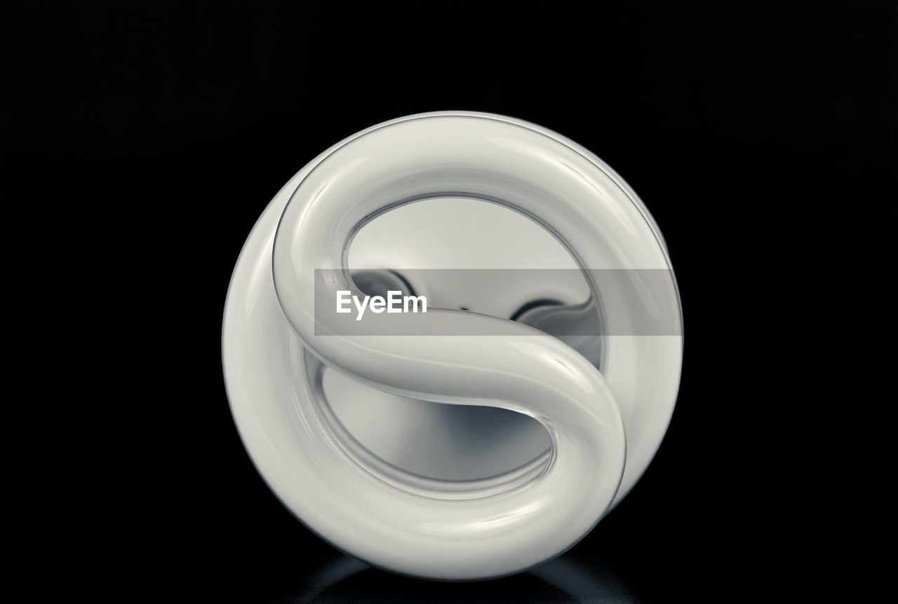 Close-up of energy efficient lightbulb against black background