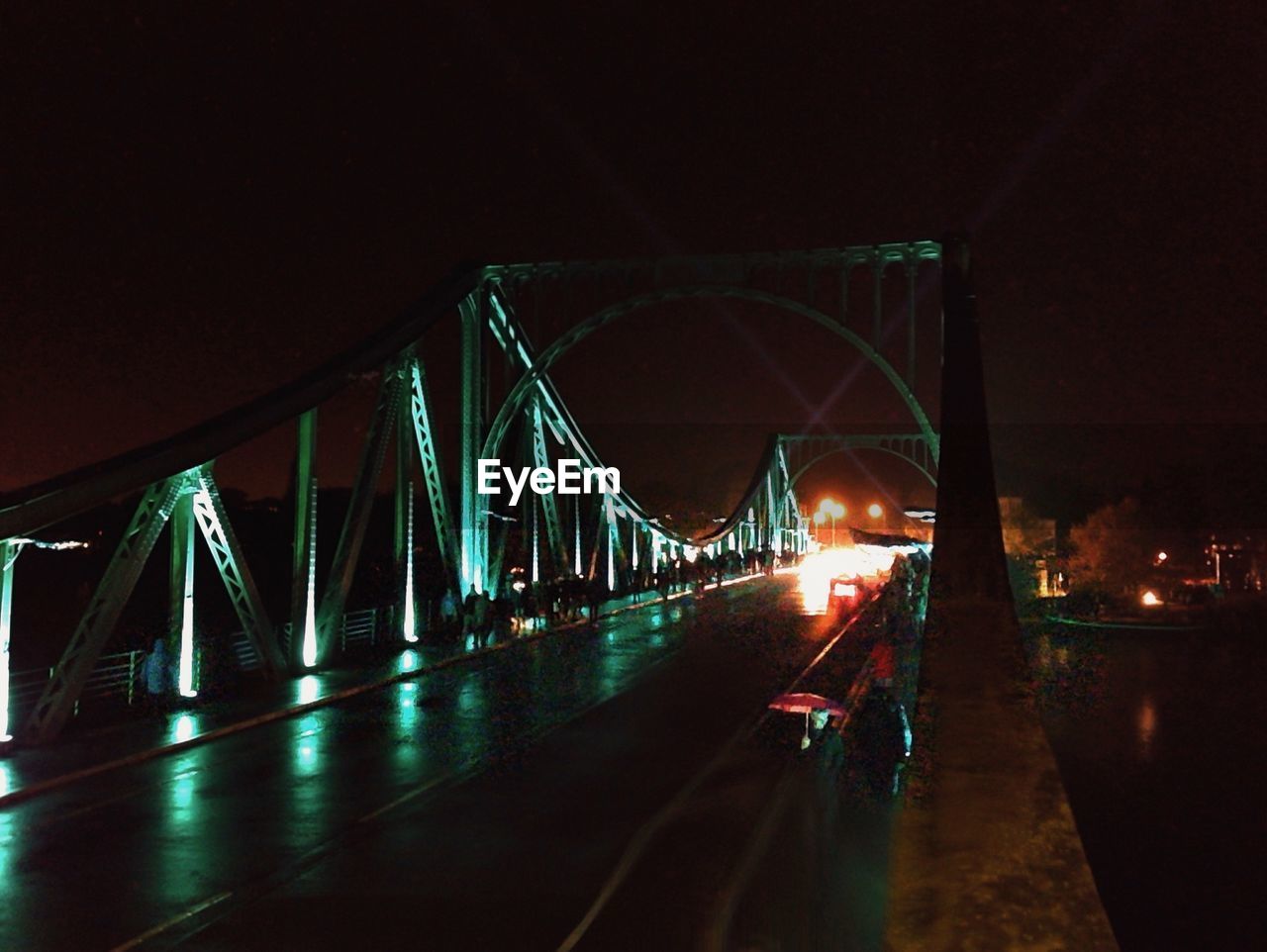 Illuminated bridge at night