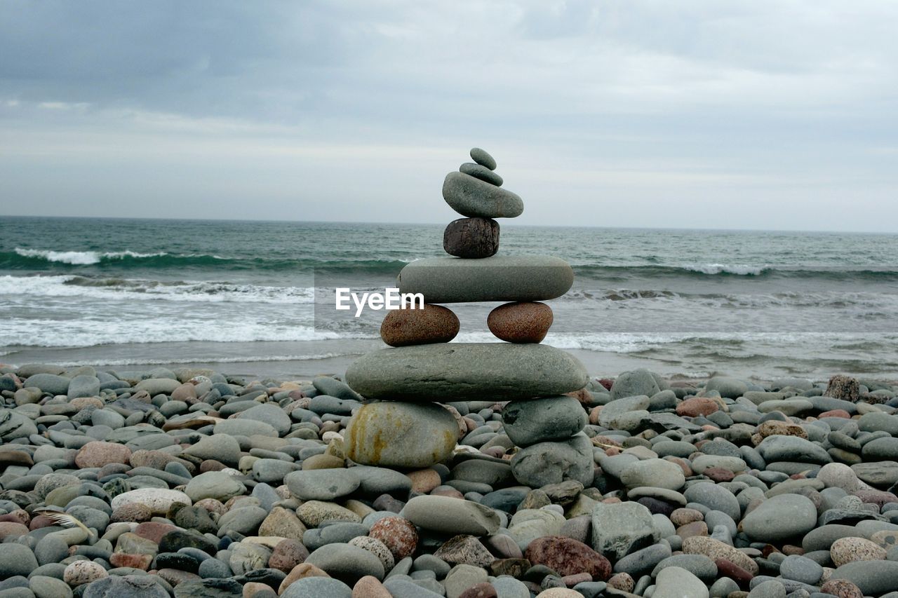 Pebbles on beach against sky