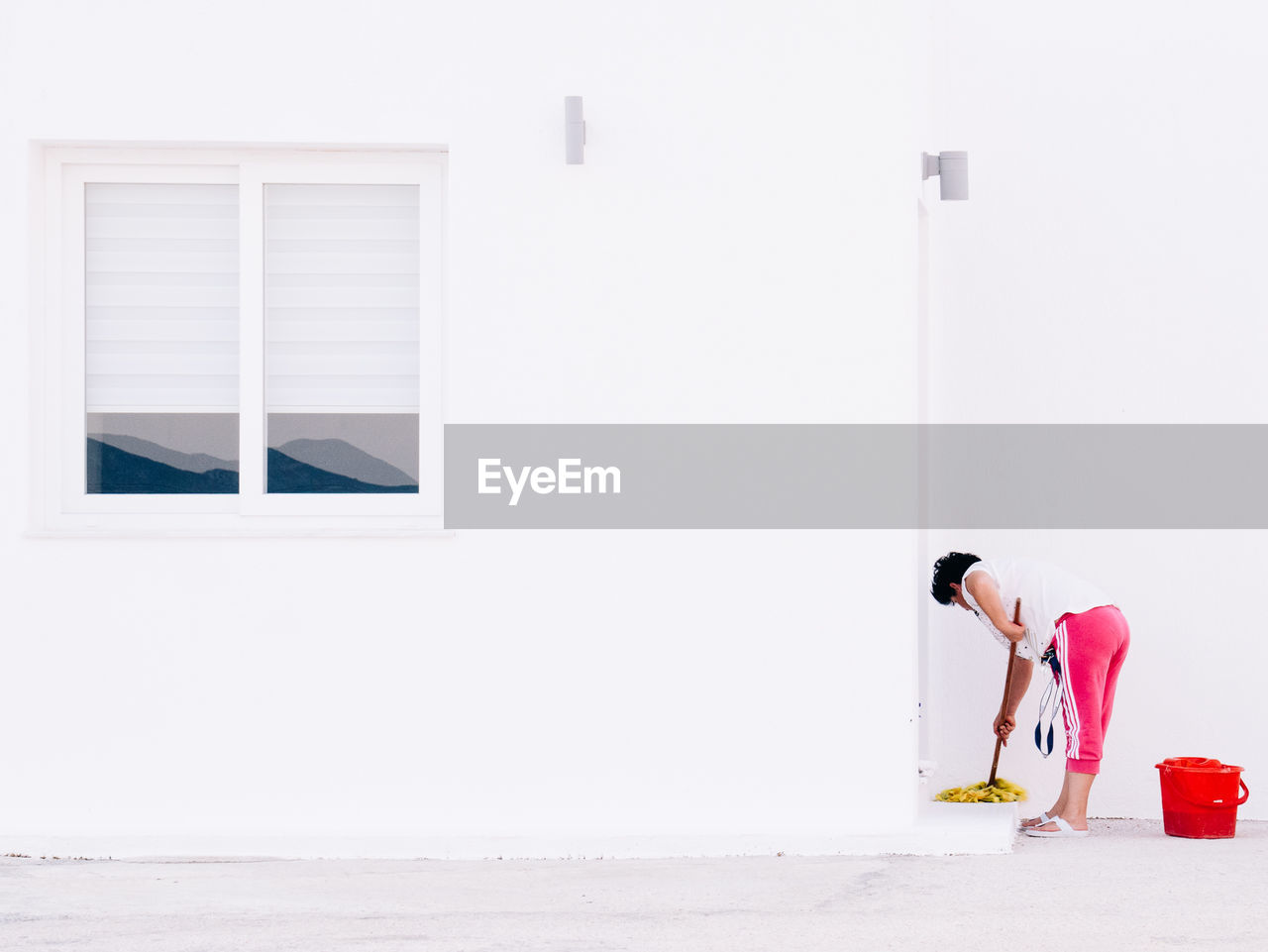 Side view of woman cleaning house