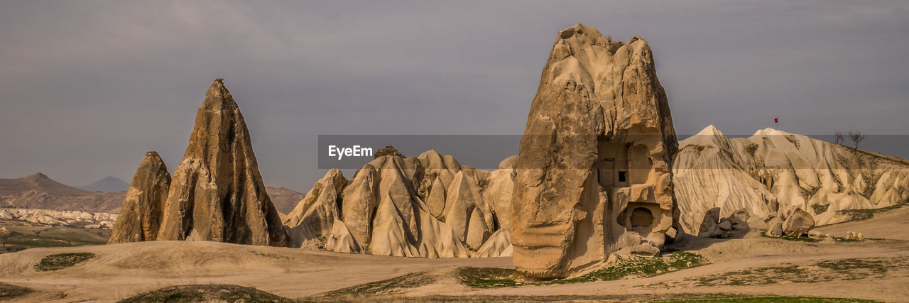 Panoramic view of arid and rocky landscape against sky in cappadocia