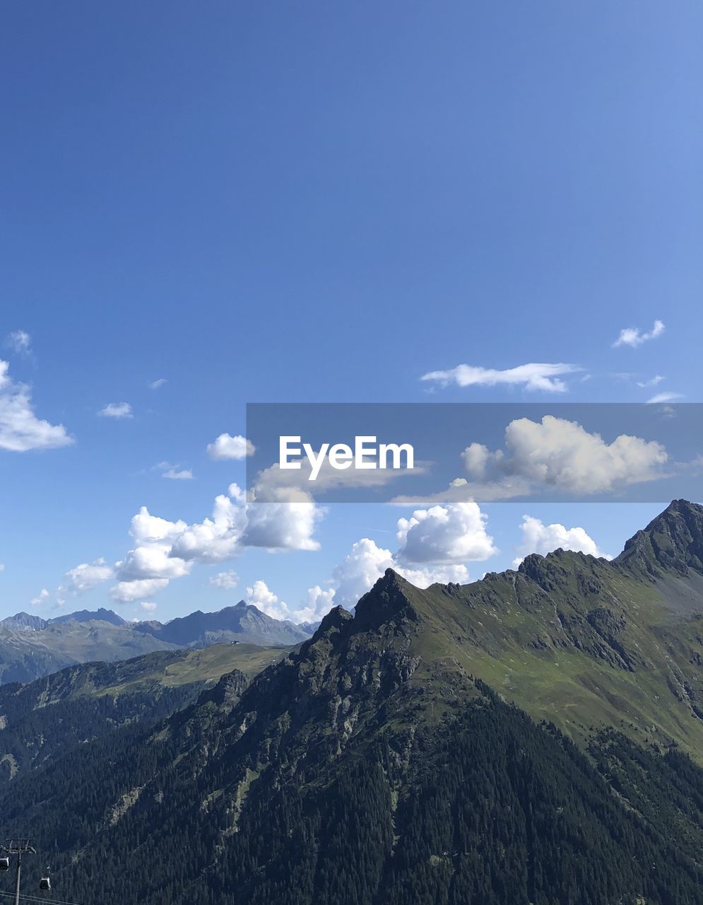 Scenic view of mountains against cloudy sky