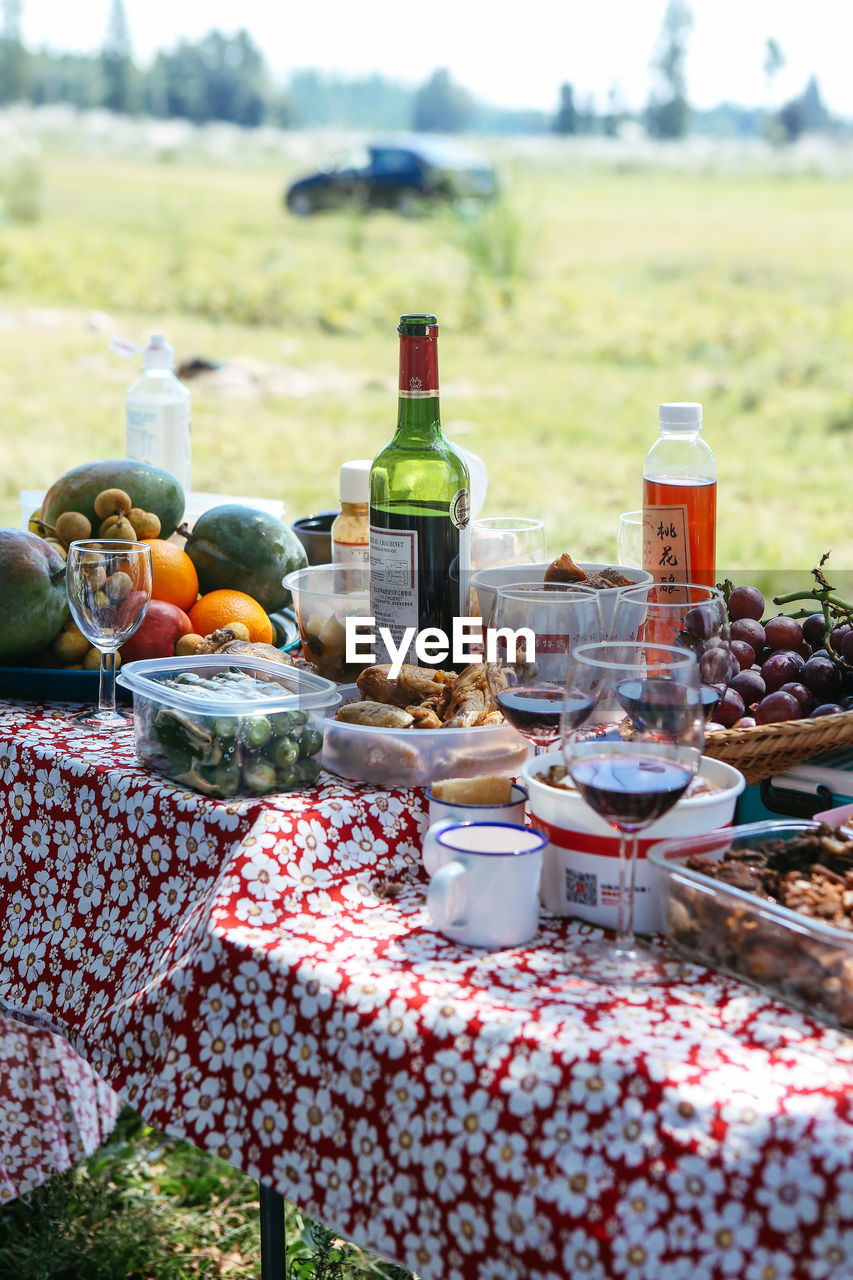 Food with drinks on table in yard