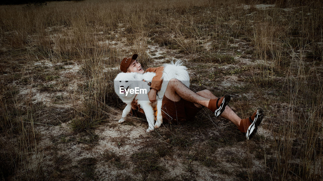 High angle view of man with dog on field