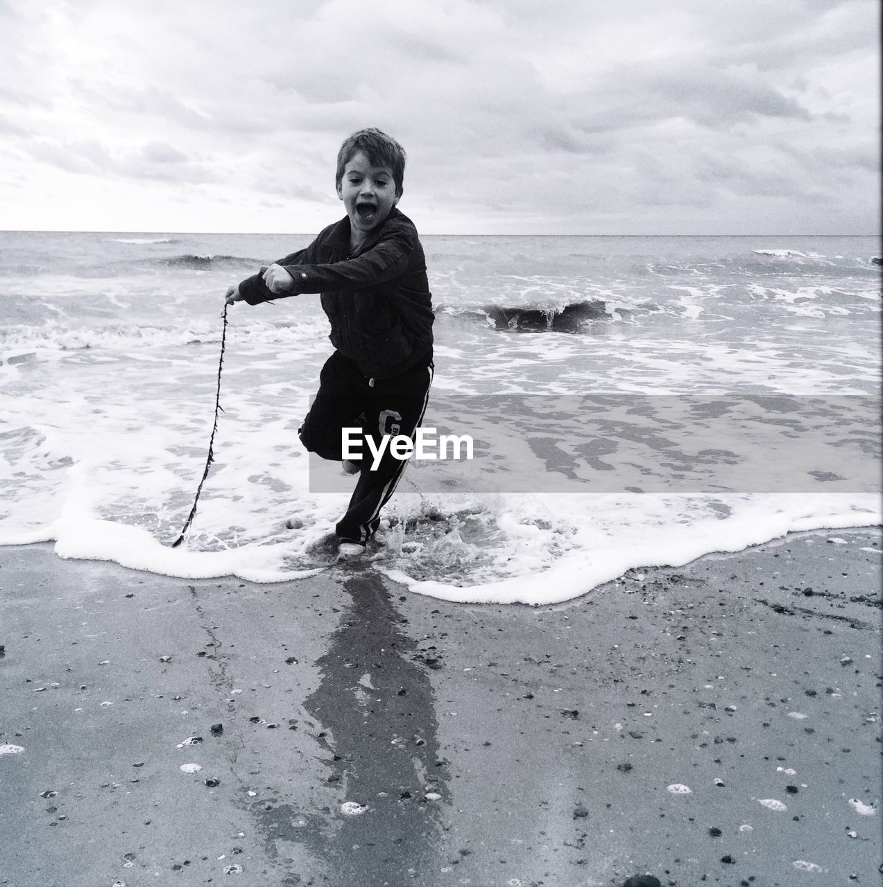 Boy standing on shore at beach