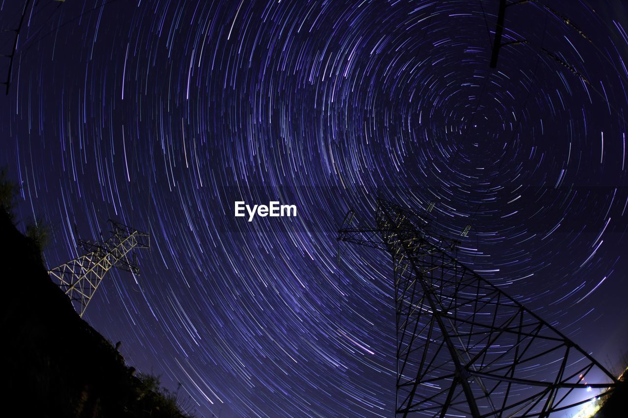 Directly below shot of star trails in sky at night