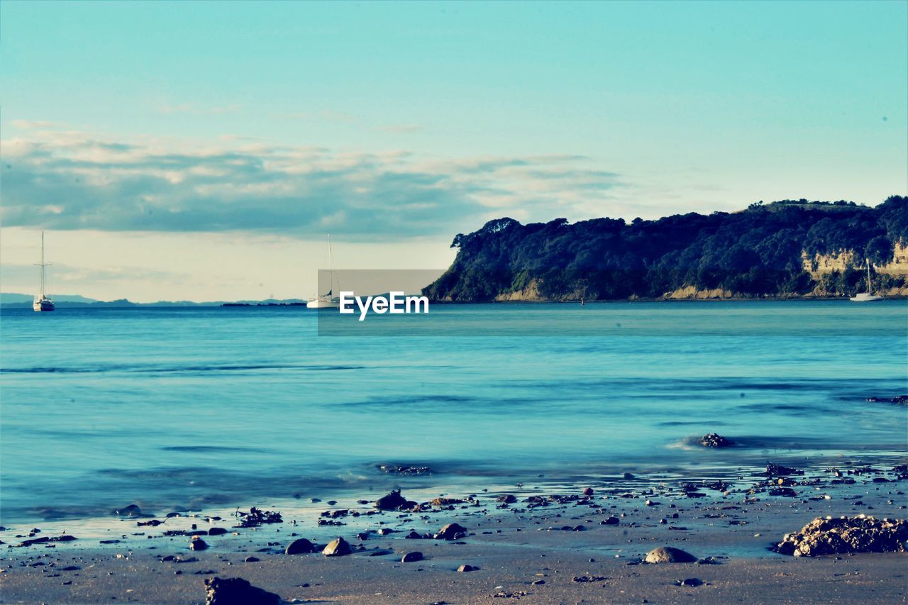 SCENIC VIEW OF SEA AND ROCKS AGAINST SKY