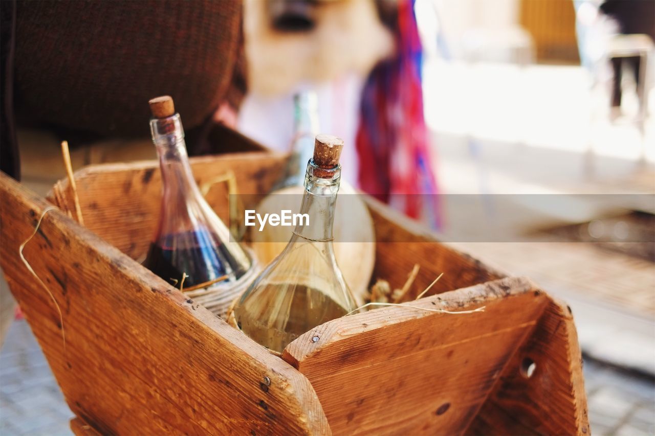 Close-up of alcohol bottles in wooden box