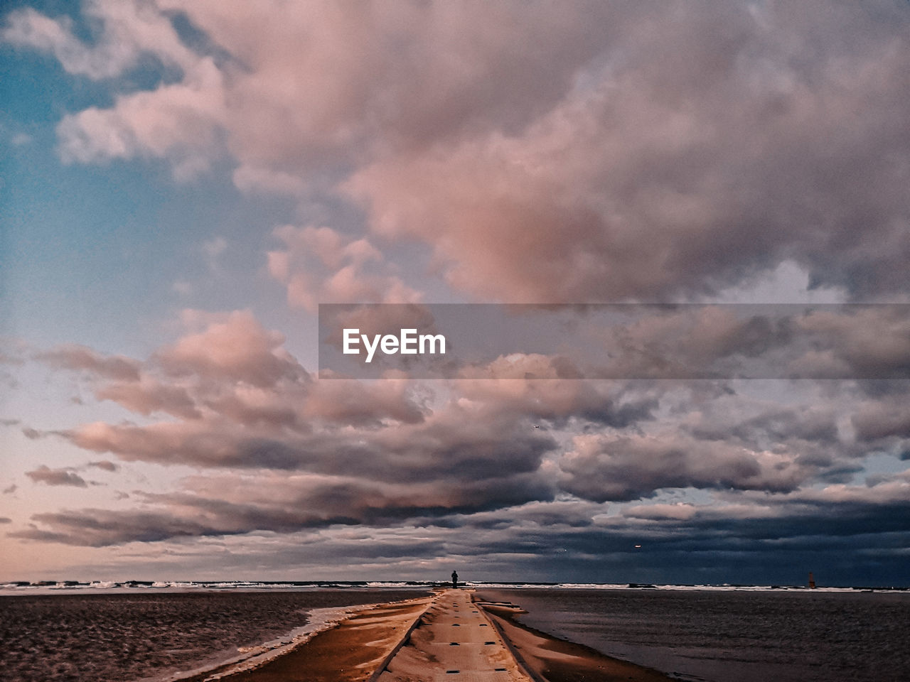 Scenic view of road against cloudy sky