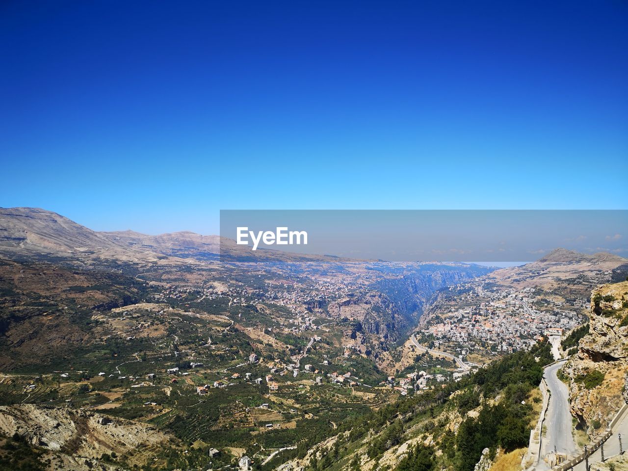 High angle view of mountains against clear blue sky