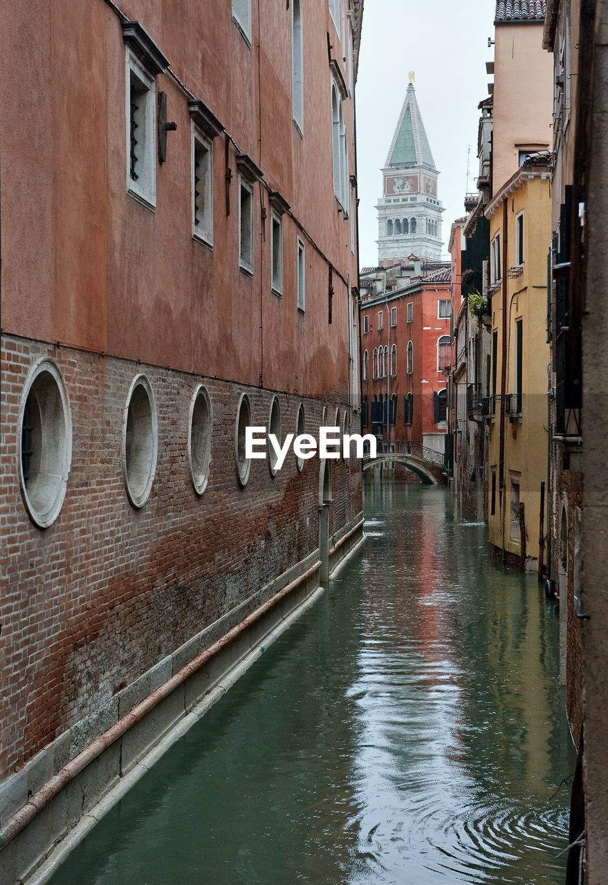 Canal amidst buildings in city