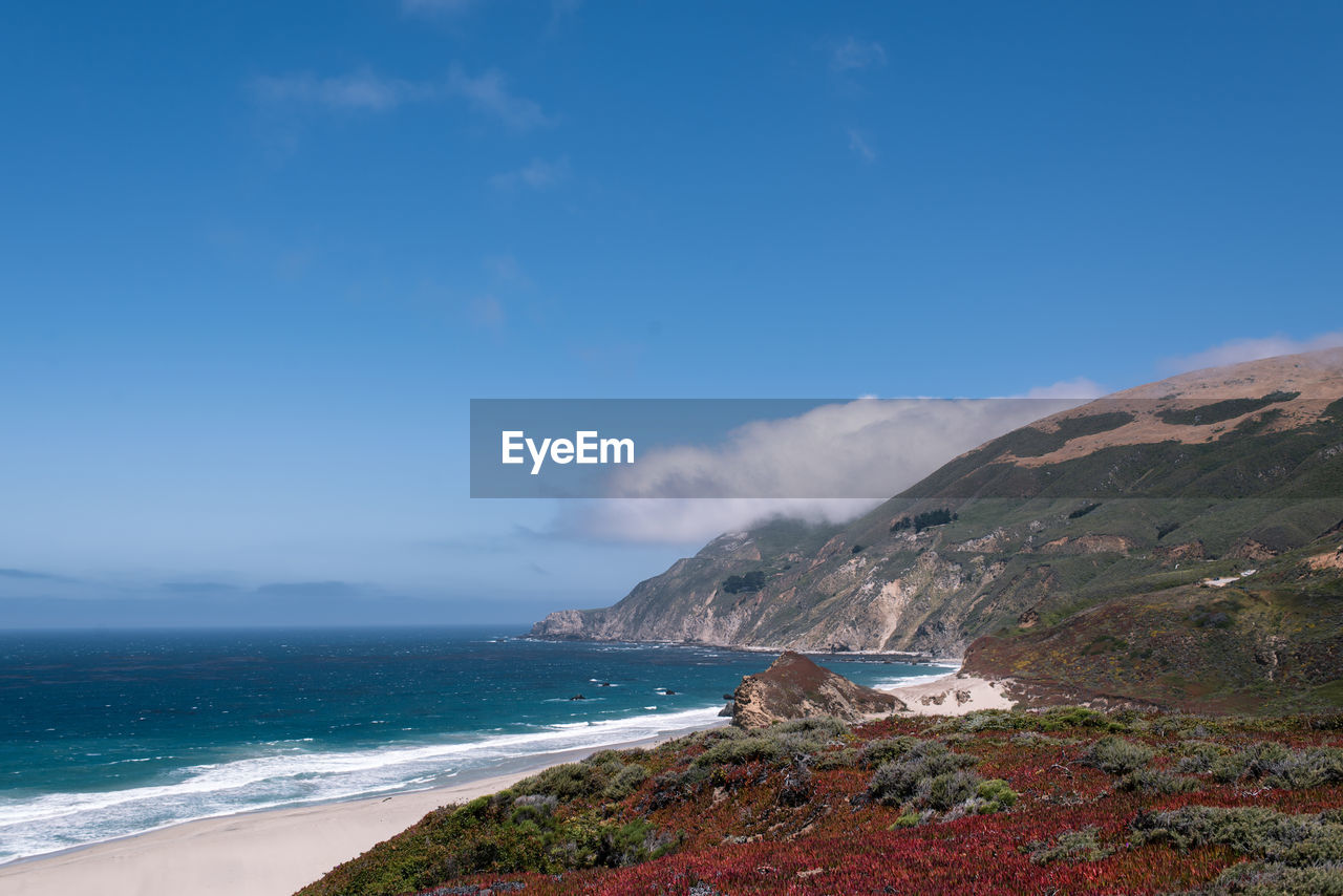 Scenic view of sea against blue sky