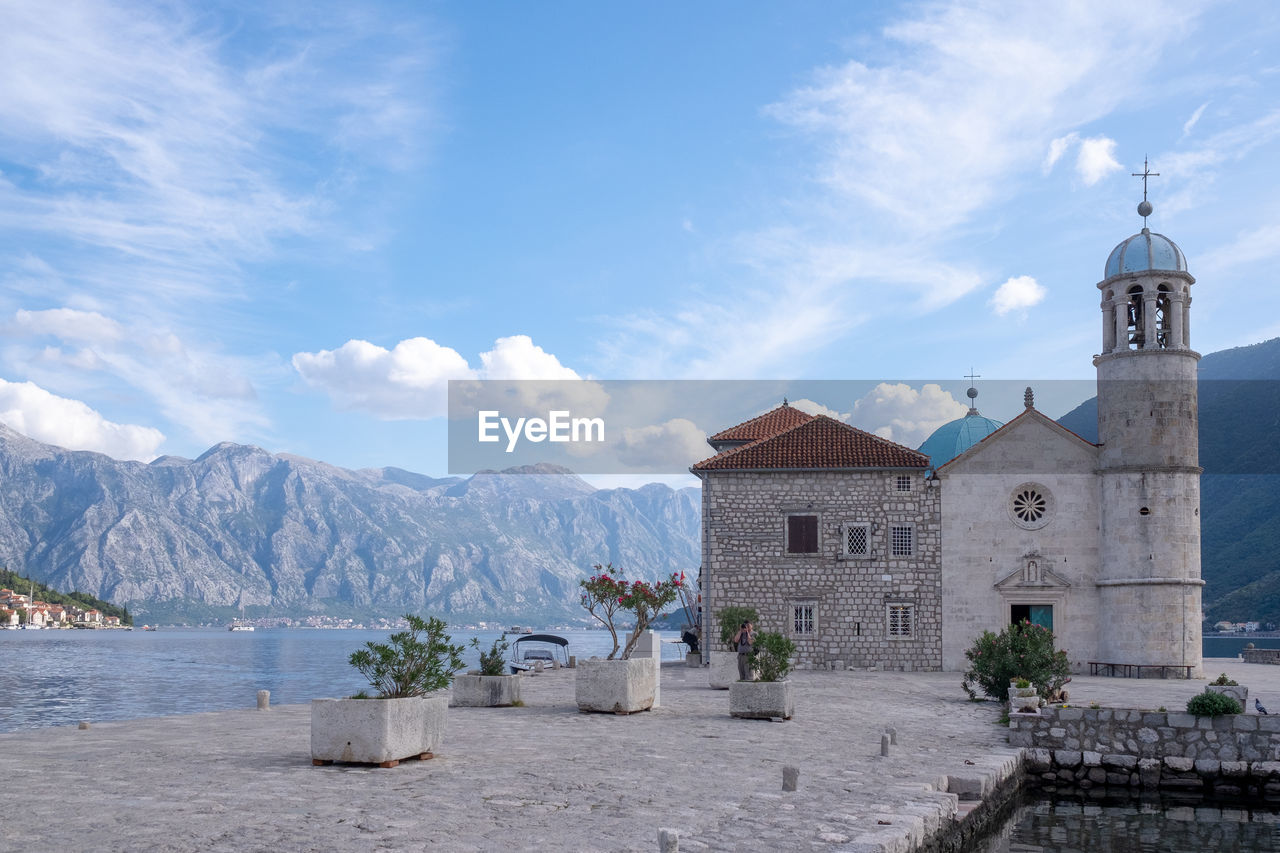 Church by building against sky