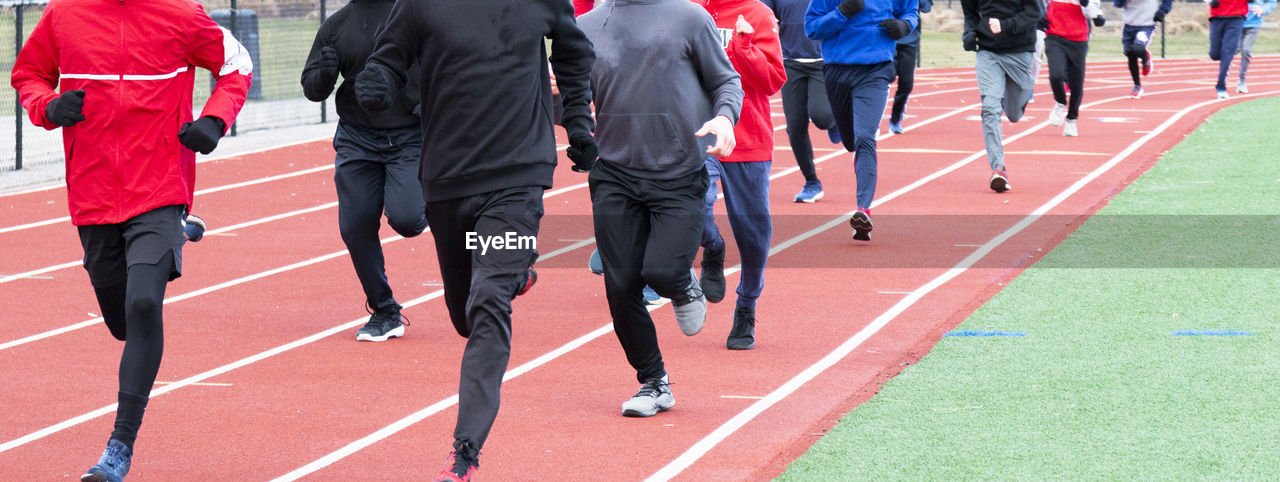 GROUP OF PEOPLE RUNNING ON THE ROAD