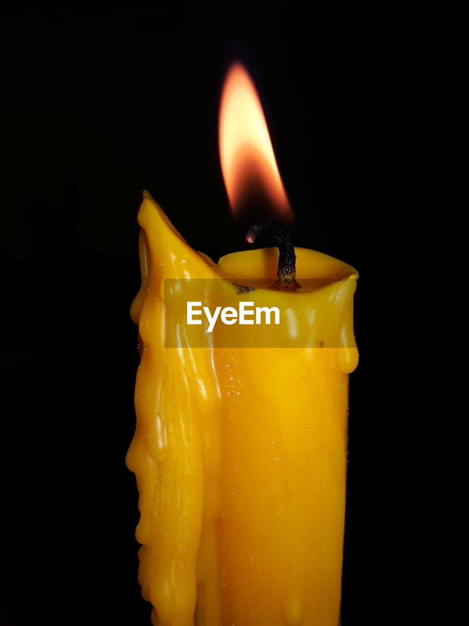 Close-up of candle against black background