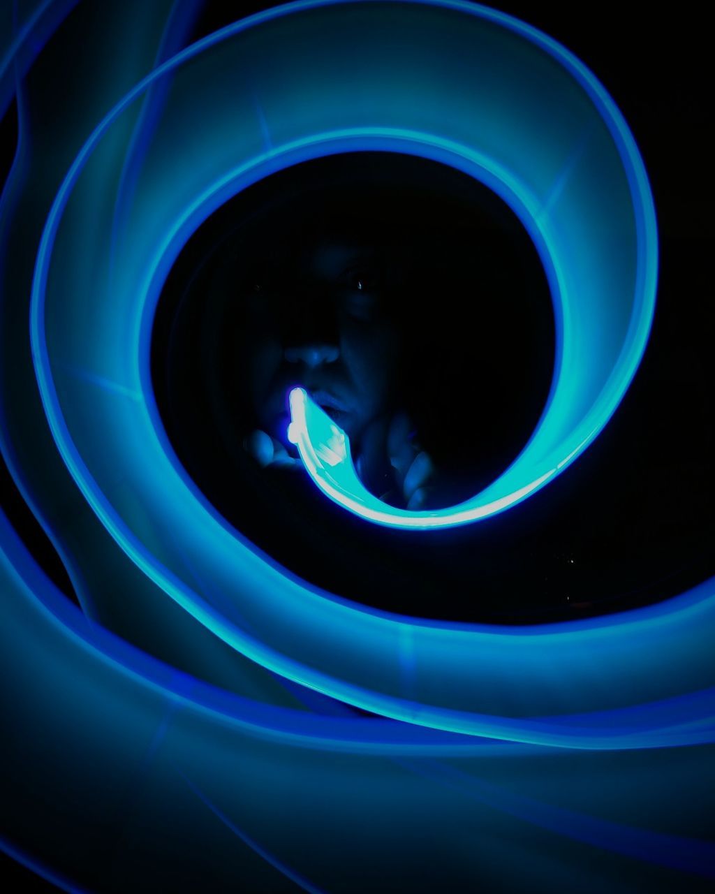 CLOSE UP OF PERSON WITH BLUE LIGHT