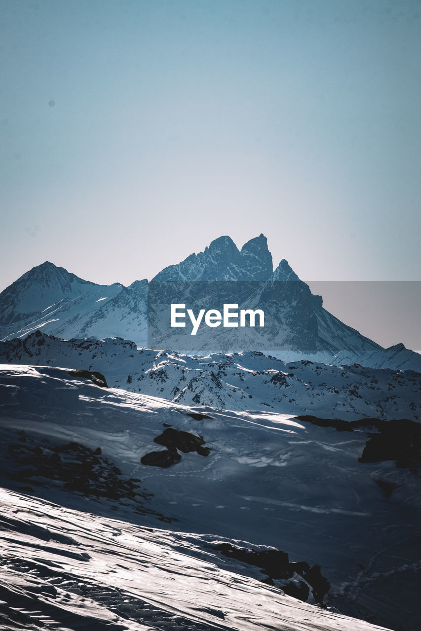 Scenic view of sea and mountains against sky