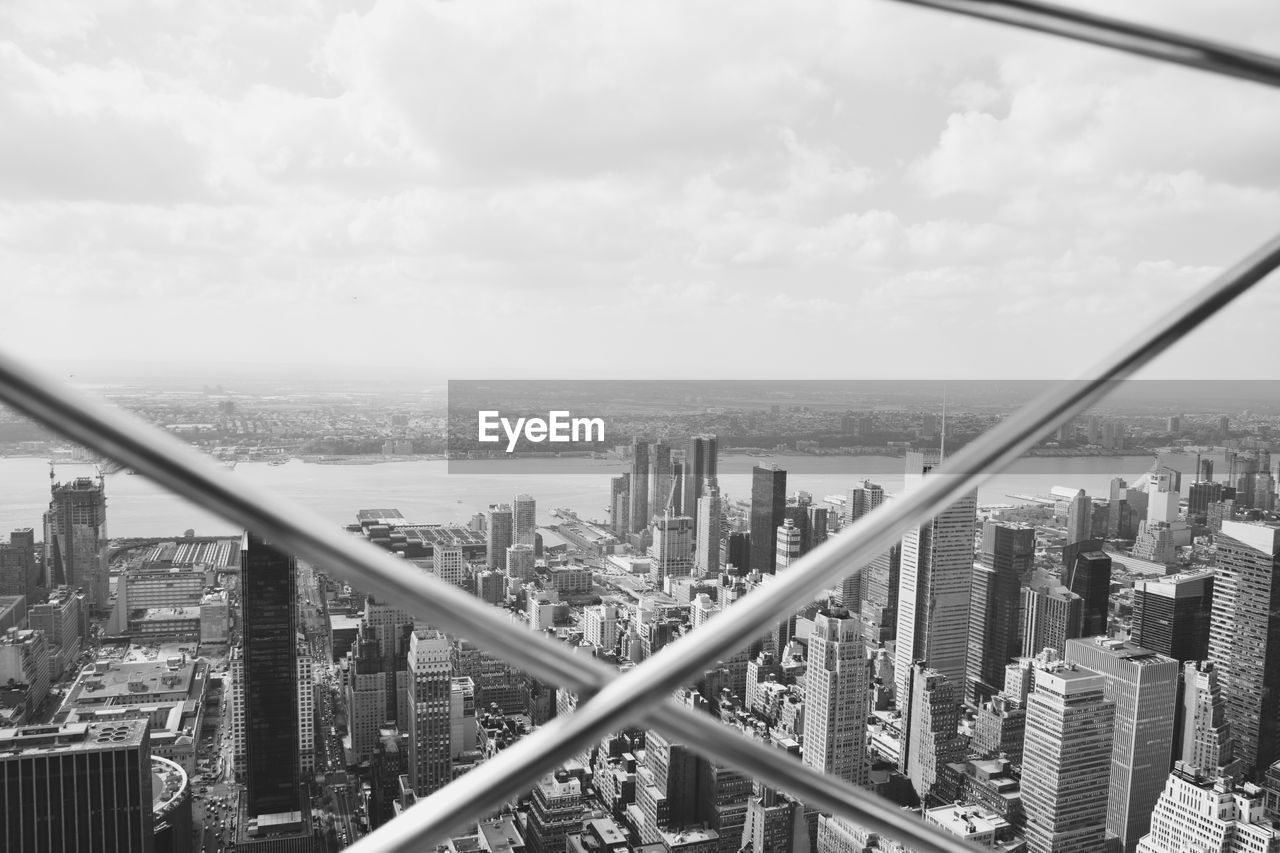 High angle view of cityscape seen from fence