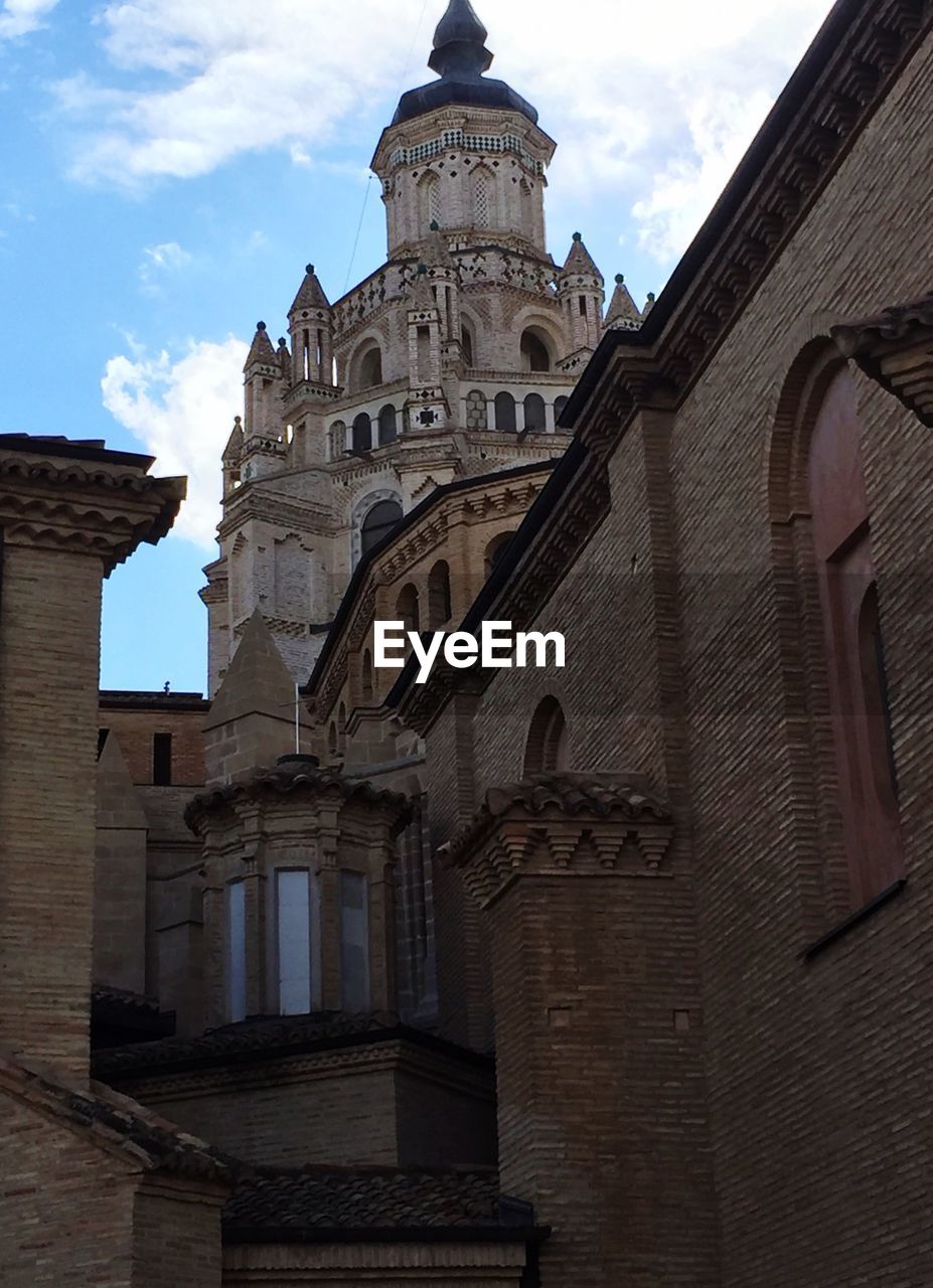 Low angle view of tarazona cathedral against cloudy sky