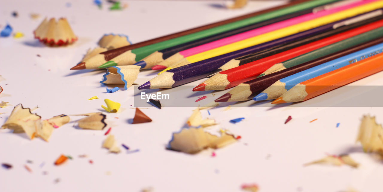 Close-up of pencil shavings over white background