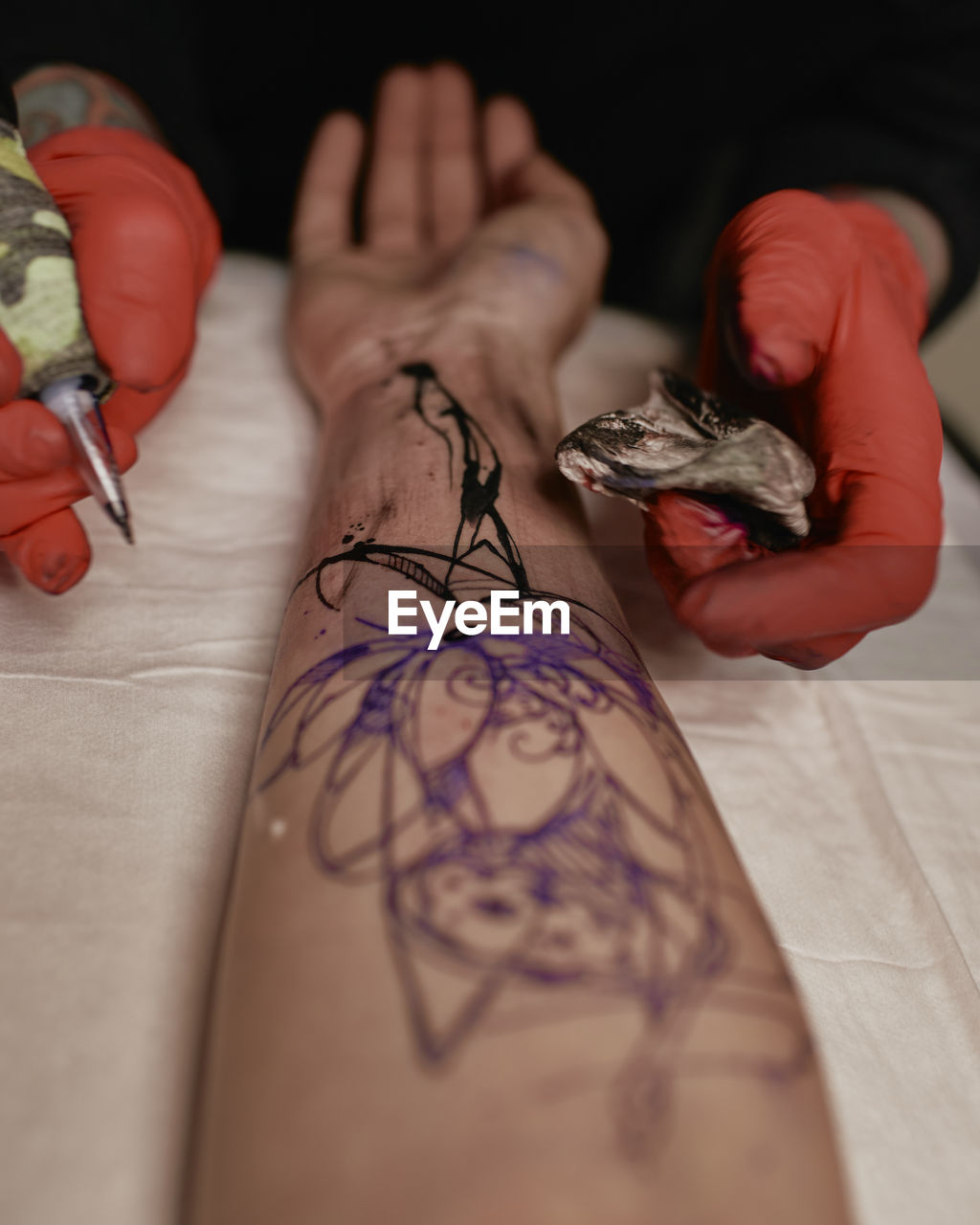 Close-up of hand tattooing