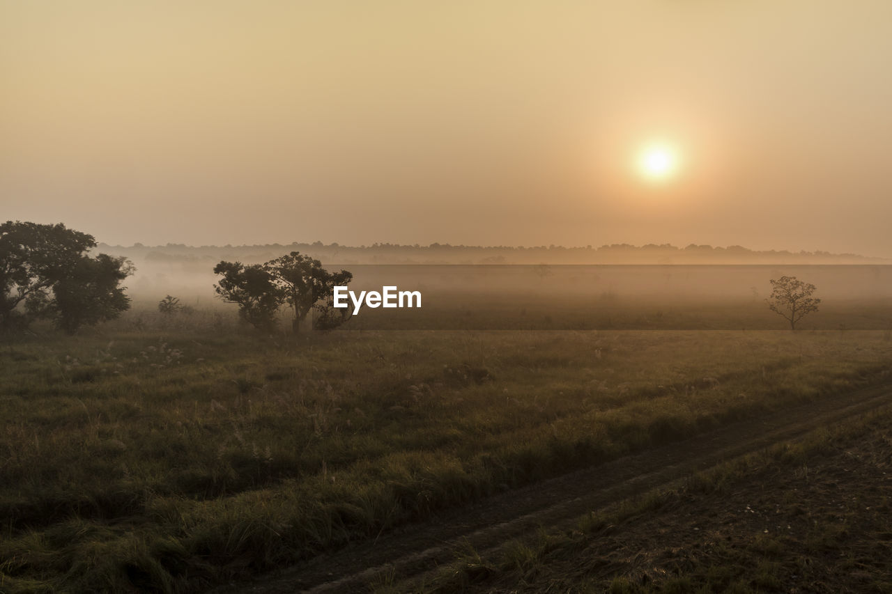 SCENIC VIEW OF LANDSCAPE AGAINST SKY AT SUNSET