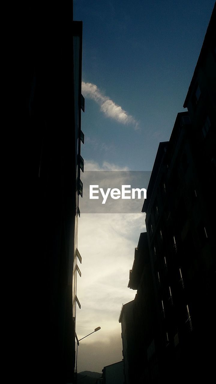 LOW ANGLE VIEW OF BUILDINGS AGAINST SKY AT SUNSET