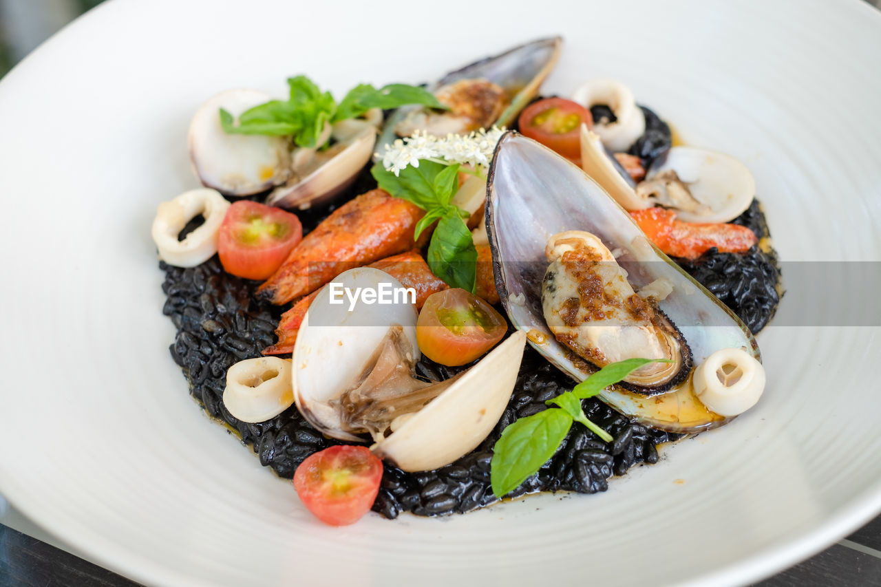 Italian riso pasta tossed in black squid ink