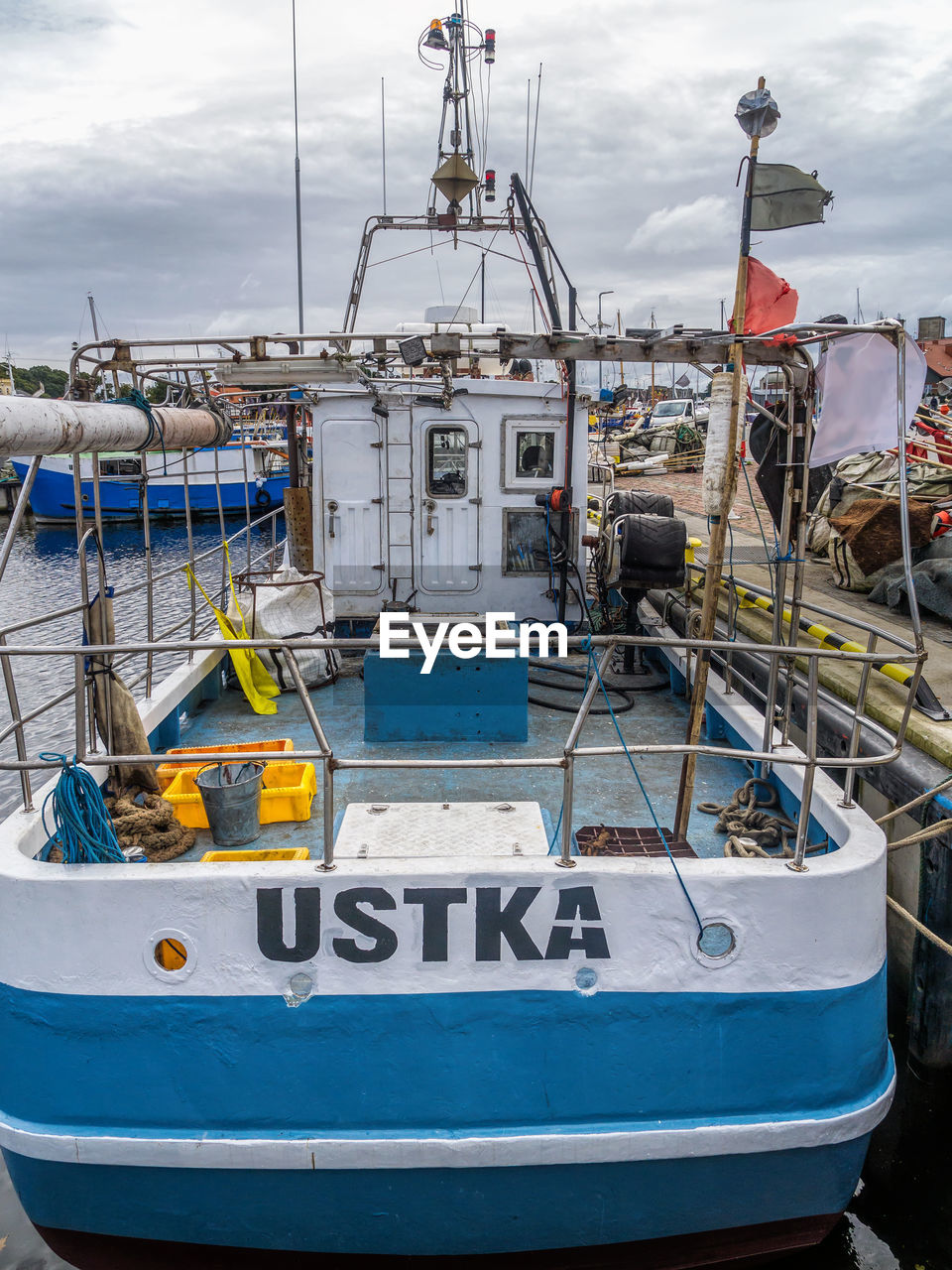 BOATS MOORED AT HARBOR