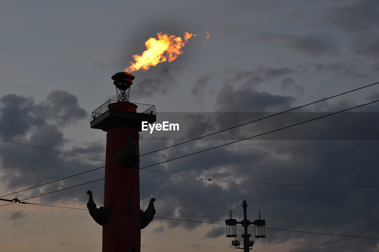 Fire torch on rostral column against sky