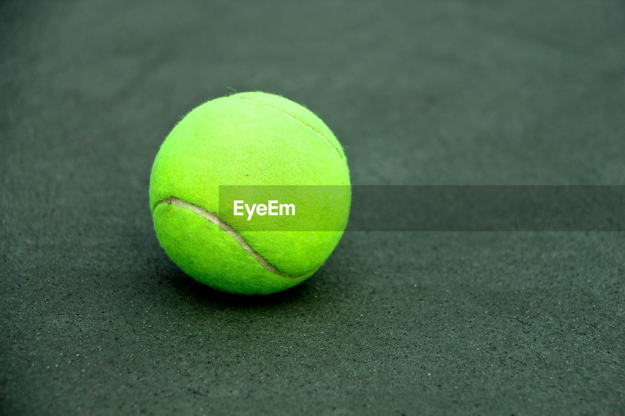 Close-up of tennis ball on court