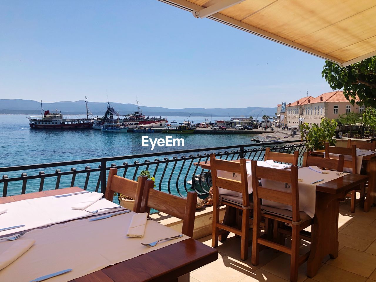 View of restaurant by sea against clear sky and sea